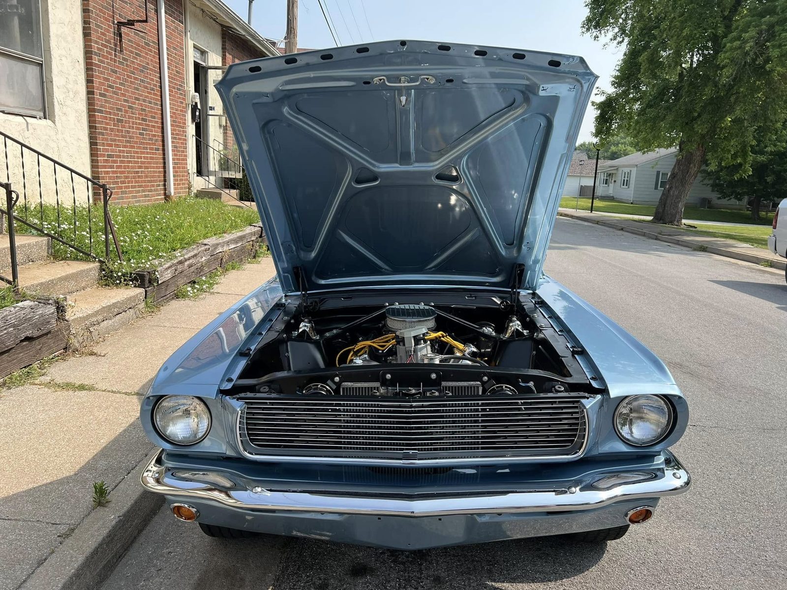 A Mustang coupe in pale blue, hood up
