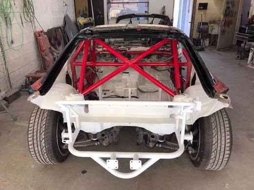 A front subframe painted white, suspension refitted