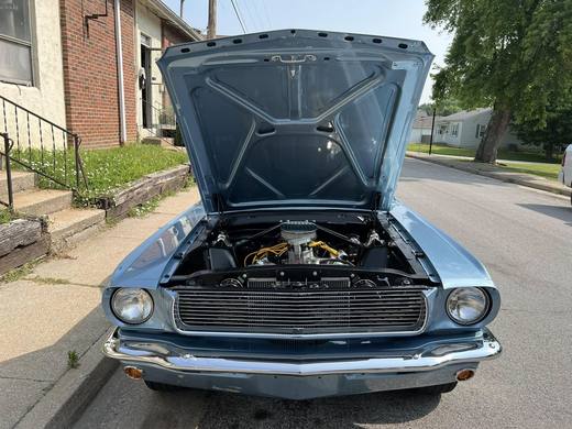A Mustang coupe in pale blue, hood up