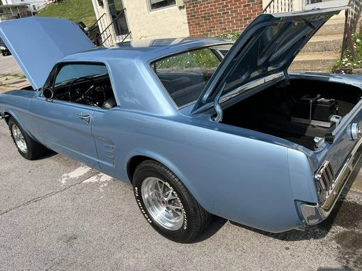 The Mustang with doors open, interior stripped