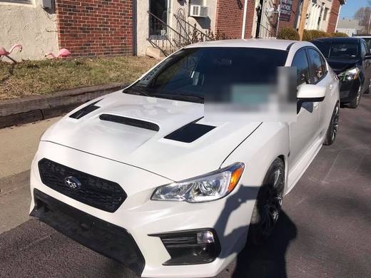 A white WRX, hood scoop and all