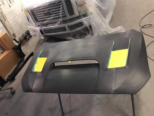 A black hood with a scoop, masked and ready