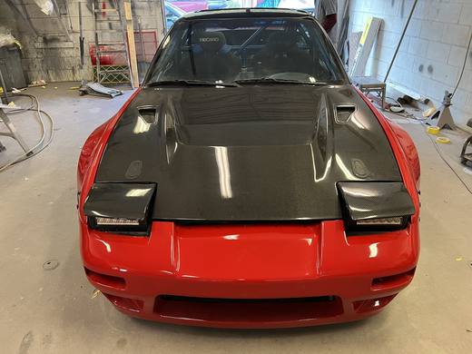 A red 240SX nose with a carbon hood